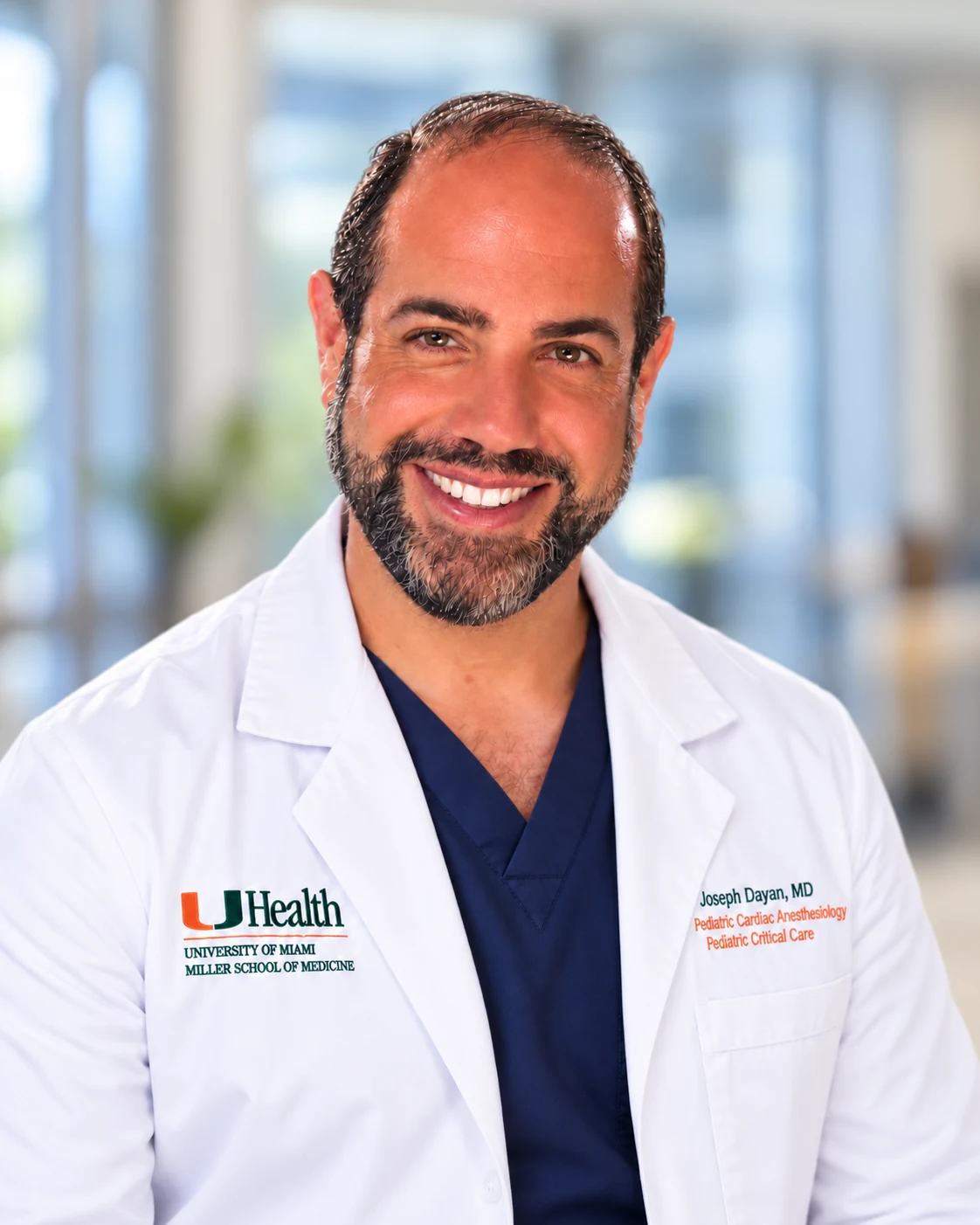 Dr. Joseph Dayan wearing a white medical coat with his name and specialties